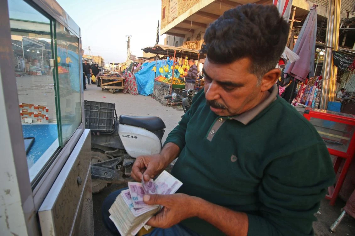 A man changes US dollars for Iranian rials. (AFP)