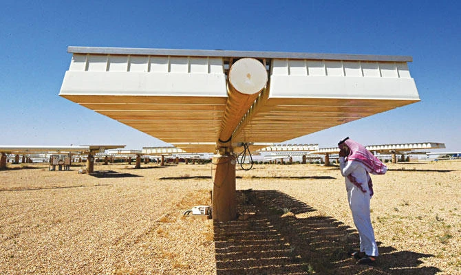 A Saudi man under the shade of a solar panel at a solar plant in Uyayna, north of Riyadh. This year Saudi Arabia announced a deal with Japan’s SoftBank to build the world’s biggest solar plant. (AFP)