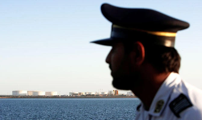 A security personnel looks on at oil docks at the port of Kalantari in the city of Chabahar, 300km east of the Strait of Hormuz, Iran, in this January 17, 2012 file photo. (REUTERS)