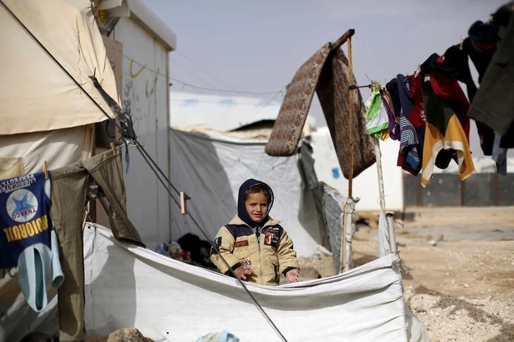 A Syrian refugee boy plays in front of his family tent at the Al Zaatri refugee camp, in the Jordanian city of Mafraq, near the border with Syria, January 18, 2016. (Reuters)