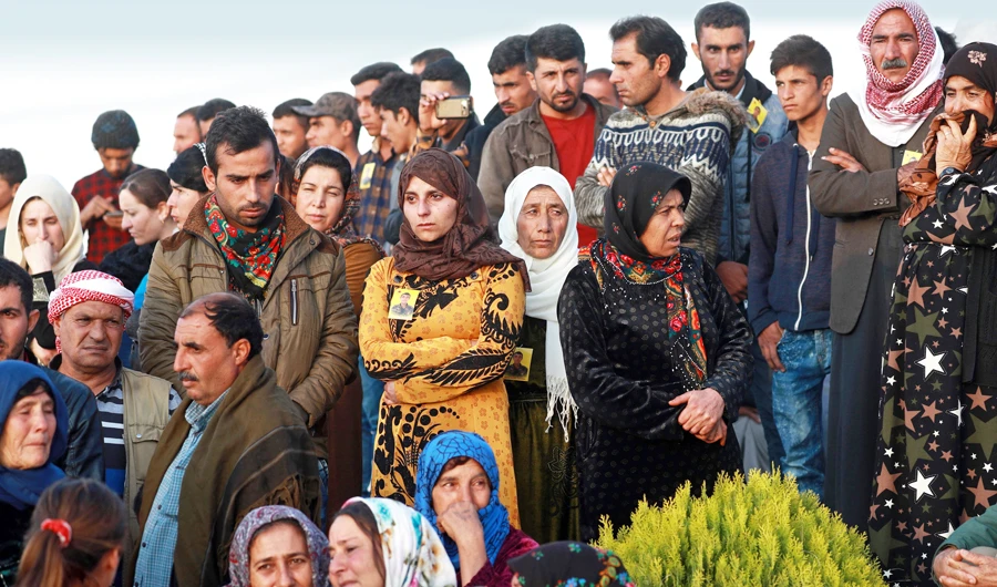 People attend the funeral of a fighter from the Syrian Democratic Forces in the northern Syrian town of Kobani. (AFP)