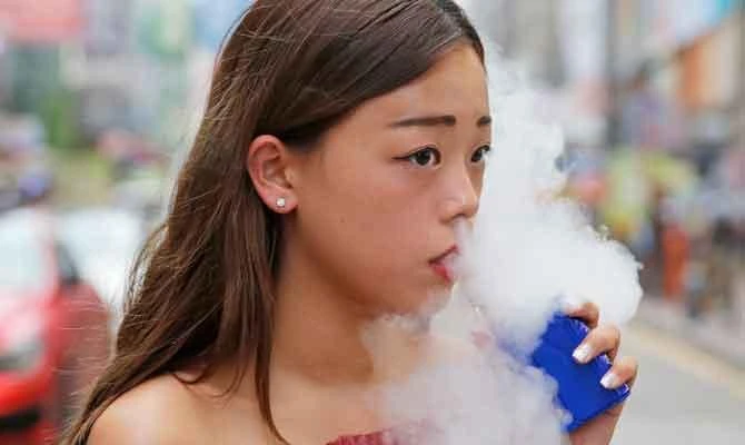In this Oct. 13, 2018, photo, Jamie Tsang, 20, smokes e-cigarette In Hong Kong. (AP)