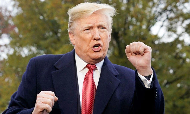 US President Donald Trump speaks to reporters as he departs the White House en route to Paris from Washington, US, November 9, 2018. (REUTERS)