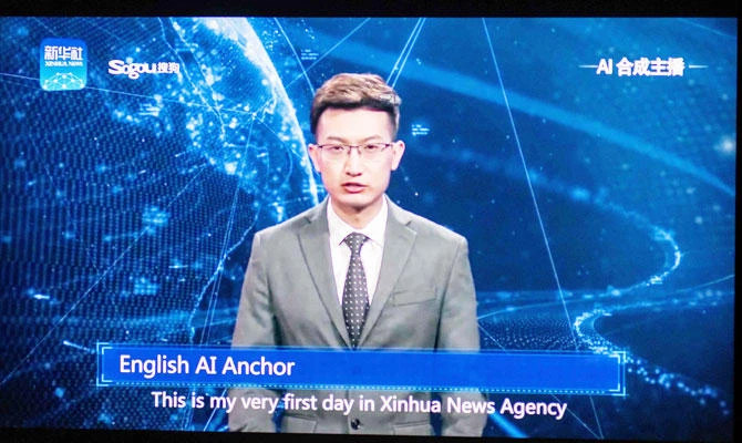 This photo illustration shows a man watching an artificial intelligence (AI) news anchor from a state-controlled news broadcaster, on his computer in Beijing on November 9, 2018. (AFP)