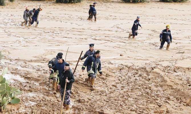 Civil defense members look for missing people after rain storms unleashed flash floods in Madaba city, near Amman. (Reuters)
