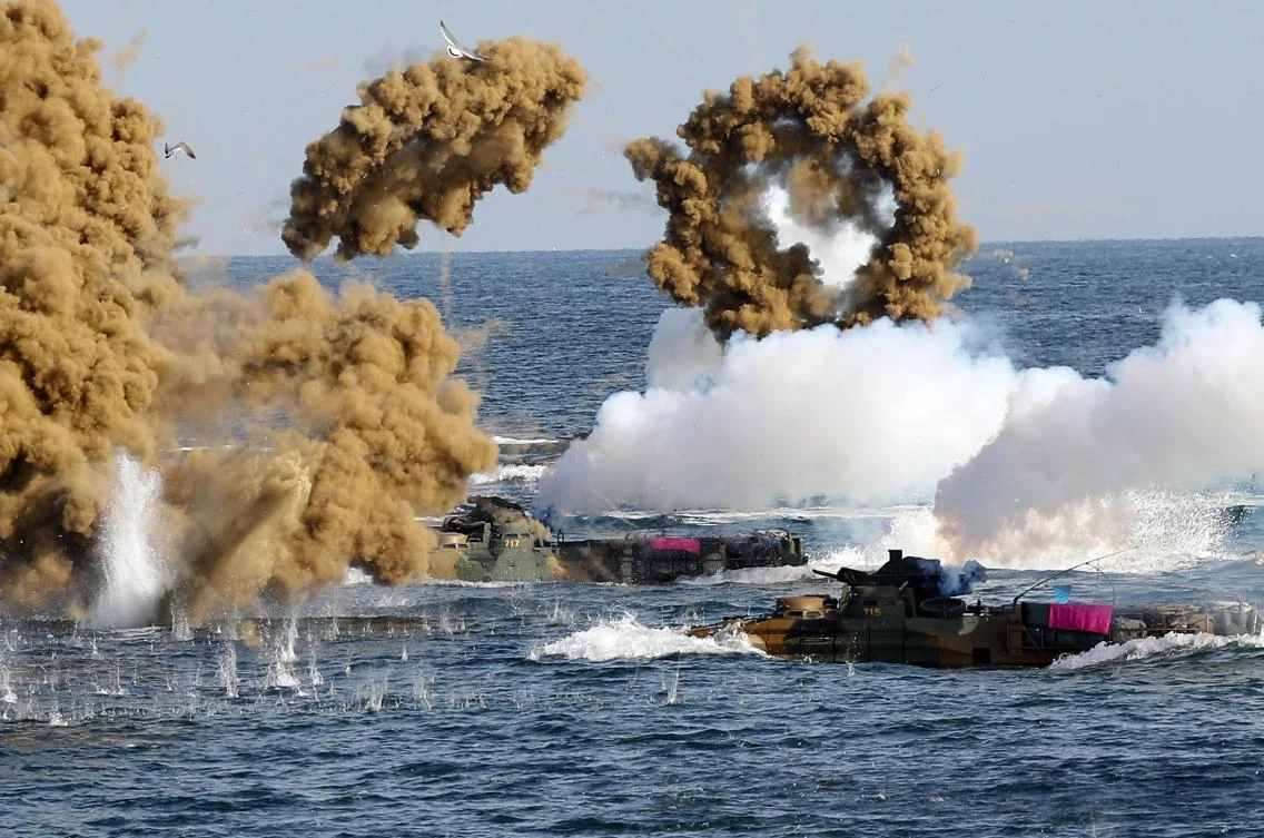 South Korean marine amphibious assault vehicles fire smoke shells on the seashore during the small-scale military training with their American counterparts. (Yonhap/AFP)