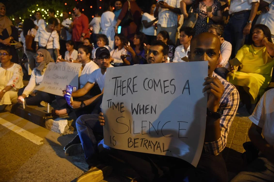 Supporters hold candles and placards in Colombo on Sunday, November 11, to protest the sacking of the Sir Lankan parliament. (AFP)