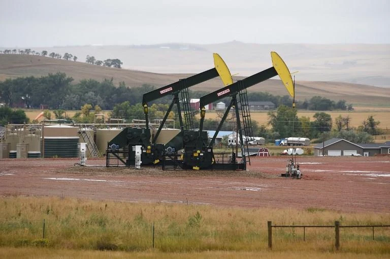 US crude production increased to a record 11.6 million barrels per day and will cross the 12 million threshold next year. (AFP)