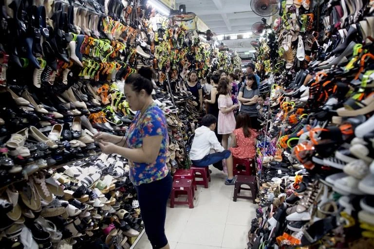 People shop for shoes at the Han Market in the central Vietnamese city of Danang. Vietnam on Monday became the seventh country to ratify a sprawling Pacific trade pact. (AFP)