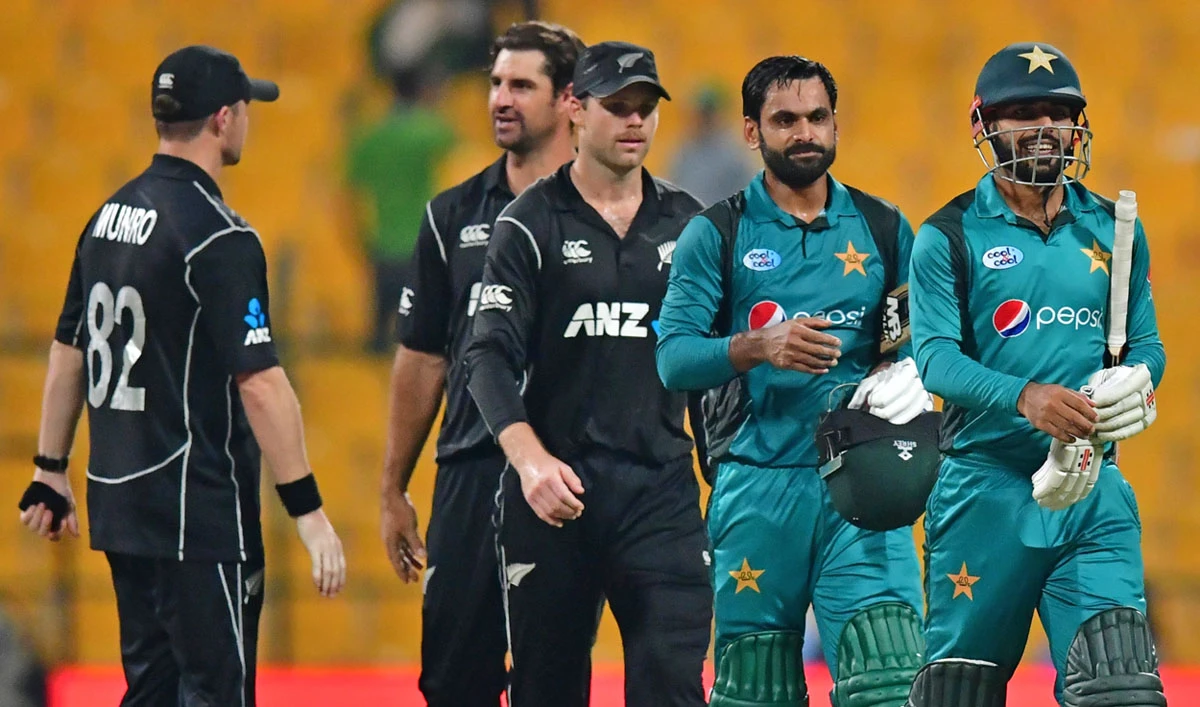 In this file photo, Pakistan cricketers Shadab Khan, right, and Mohammad Hafeez walk back to the pavilion after victory in the second one day international (ODI) cricket match between Pakistan and New Zealand at The Sheikh Zayed Cricket Stadium in Abu Dhabi on Nov. 9, 2018. (AFP/File)