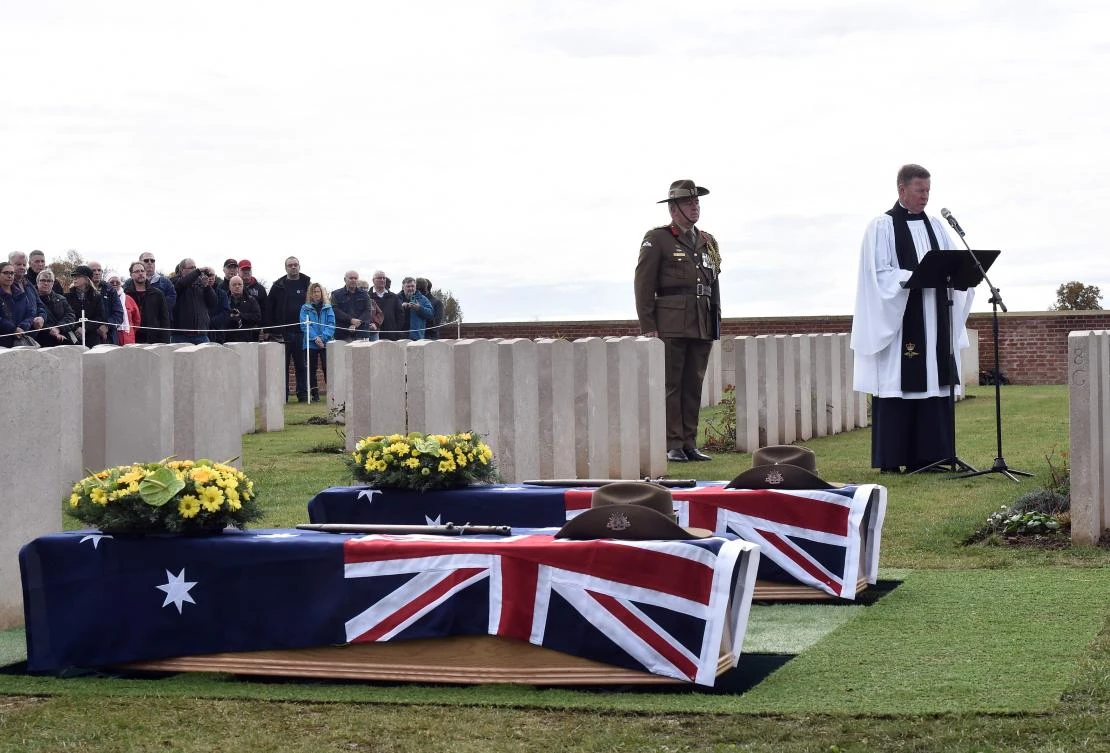 A priest delivers a sermon during the funeral of two soldiers belonging to the 24th Australian Imperial Force infantry battalion killed during World War I at a cemetary in Buissy, France. (AFP)