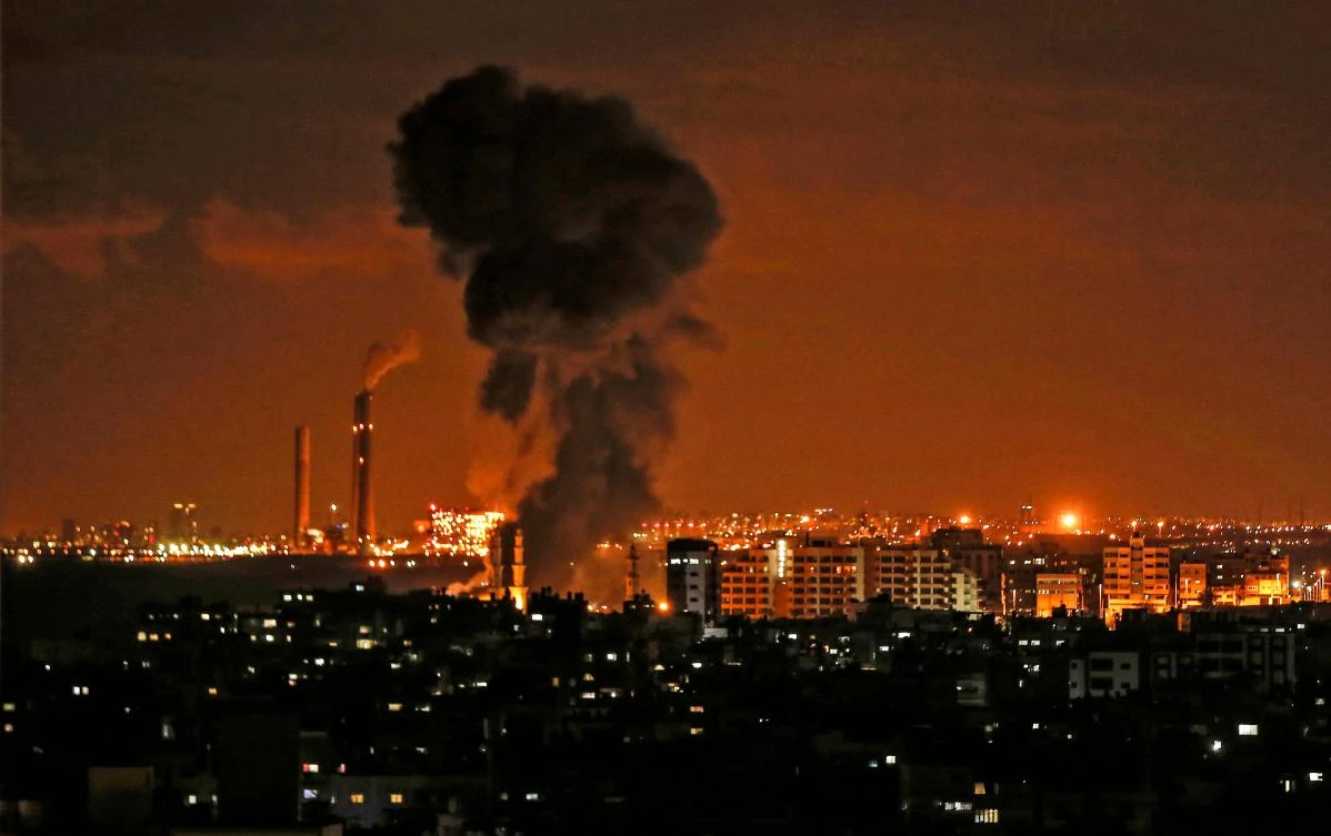 Smoke billows from a building during Israeli air strikes on the Hamas-run Palestinian enclave on Monday night, November 12. (AFP)