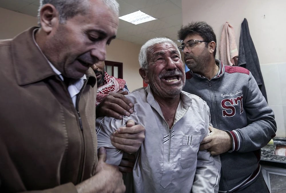 The relative of a man killed a day earlier in an Israeli air strike in Gaza after identifying his body at a hospital morgue in Beit Lahya. (AFP)