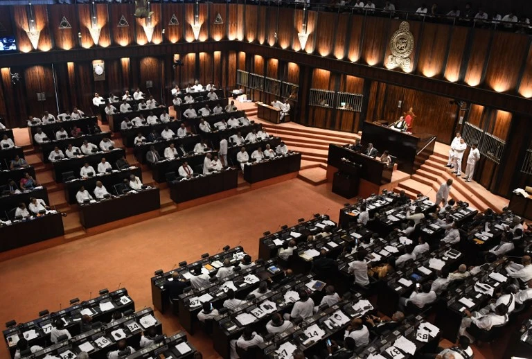 Members of the Sri Lankan parliament gather in the assembly hall in Colombo on Wednesday, November 14, as a majority voted to pass a motion of no-confidence in the controversially appointed government of Mahinda Rajapaksa. (AFP)