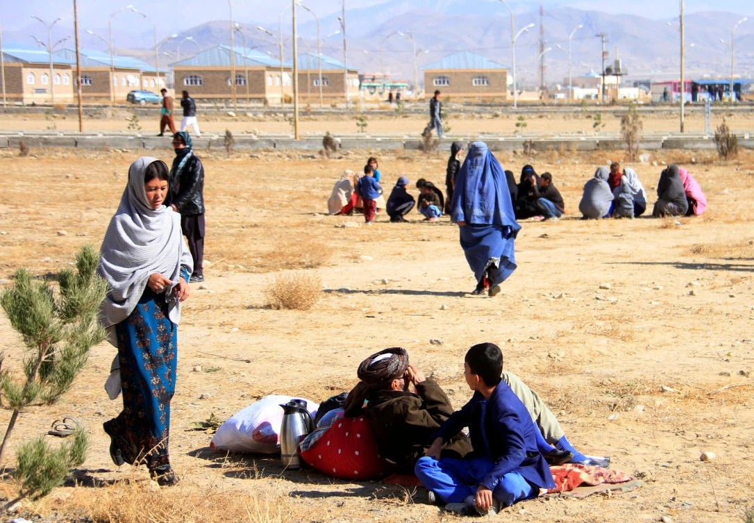 Afghan families fleeing conflict between Taliban and Afghan forces arrive in Ghazni on Wednesday, November 14. (Reuters)