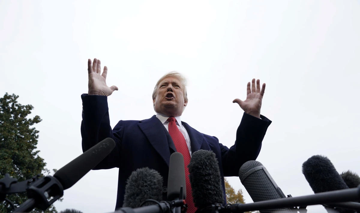 US President Donald Trump talks to reporters prior to departing for Paris, France from the South Lawn of the White House in Washington, US, November 9, 2018. (Reuters)