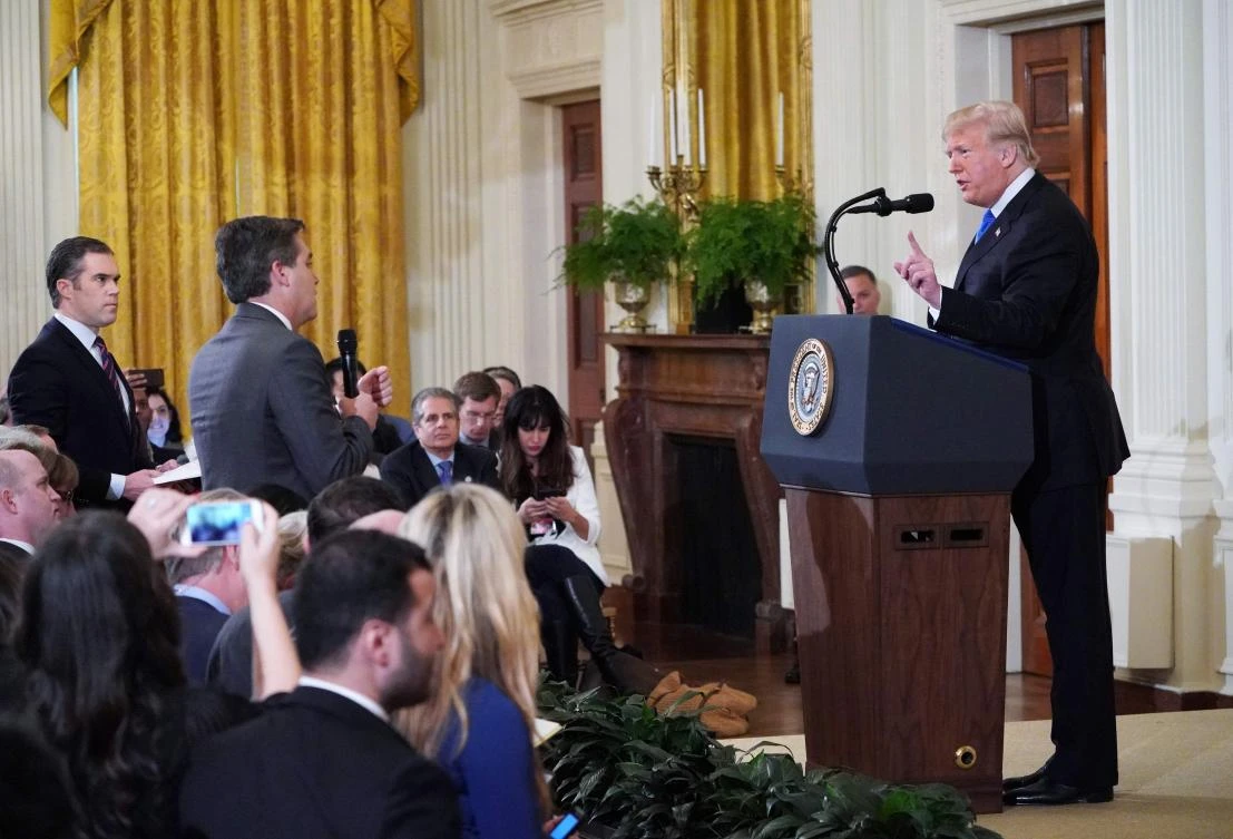 File photo taken on November 7, 2018 shows US President Donald Trump (R) getting into a heated exchange with CNN chief White House correspondent Jim Acosta (C) as NBC correspondent Peter Alexander (L) looks on during a post-election press conference in the East Room of the White House. (AFP)
