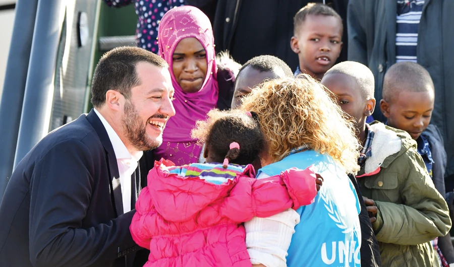 Italy’s Interior Minister and Deputy Premier Matteo Salvini welcomes migrants upon their arrival at an airport near Rome. (AFP)
