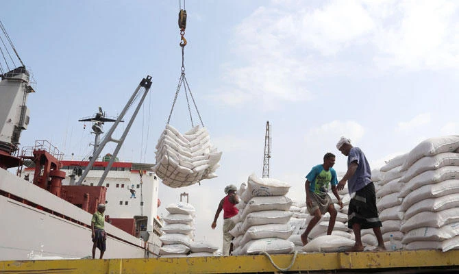 In this file photo taken on January 27, 2018, workers unload wheat assistance provided by UNICEF from a cargo ship at the Red Sea port of Hodeida. (AFP)