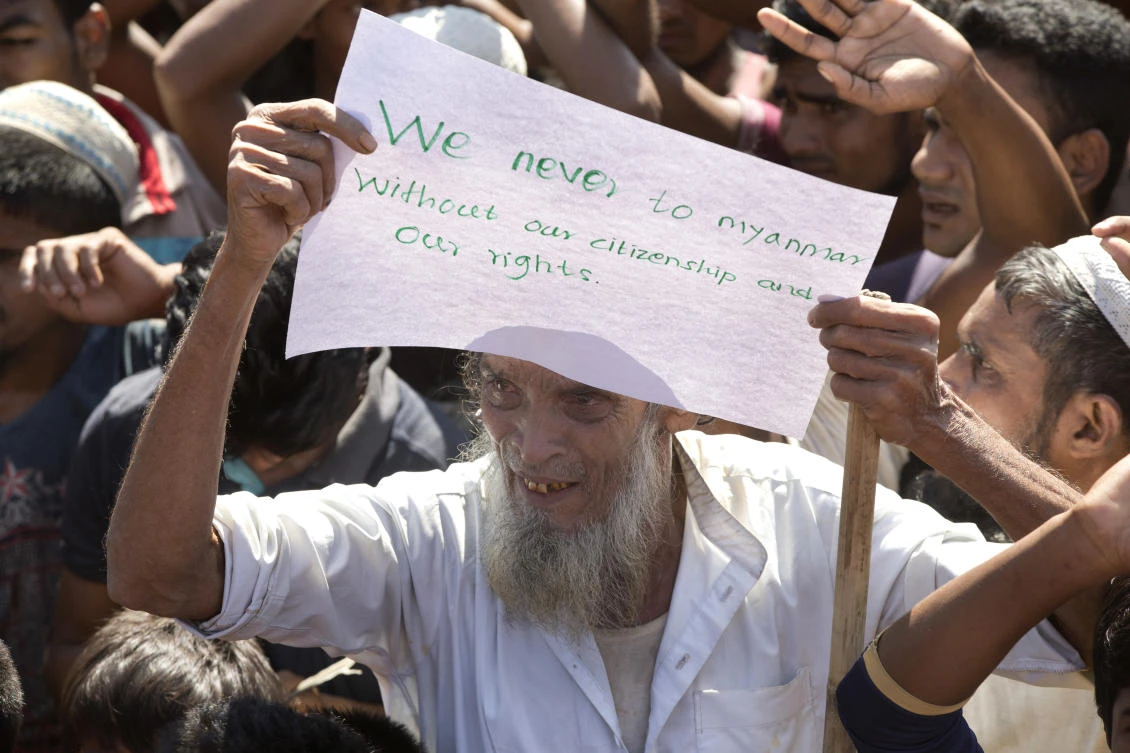 An elderly Rohingya refugee holds a placard during a protest against the repatriation process at Unchiprang refugee camp near Cox's Bazar on Thursday, November 15. (AP)