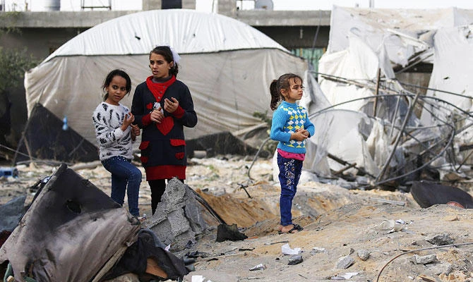 Palestinian children gather near agricultural nurseries damaged by an Israeli air strike earlier this week in Rafah in the southern Gaza Strip on November 14, 2018. (AFP)