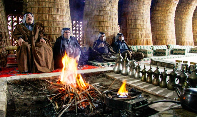 Members of an Iraqi clan gather inside a straw tent in the town of Mishkhab, south of Najaf on November 15, 2018. (AFP)