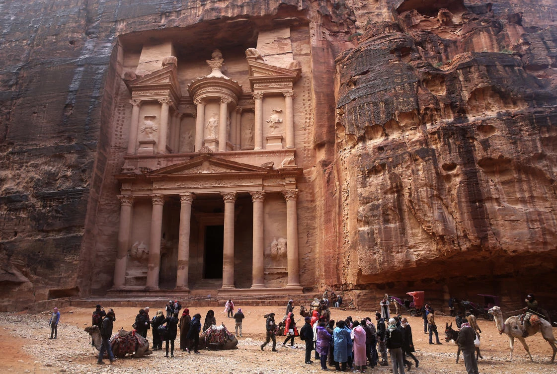 Flash floods caused by heavy rain forced hundreds of tourists to seek higher ground in the kingdom’s ancient city of Petra. (AP)