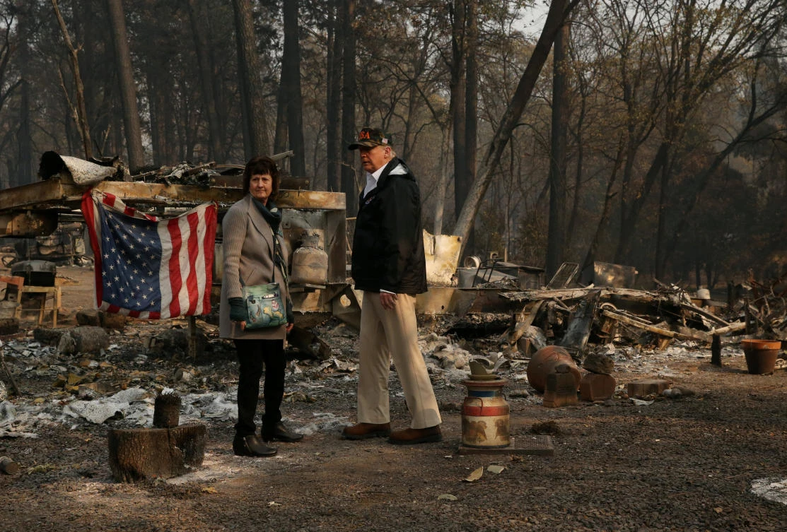 President Donald Trump visits the Skyway Villa Mobile Home and RV Park, a neighborhood destroyed by the camp fire with Mayor Jody Jones in Paradise, California. (Reuters)