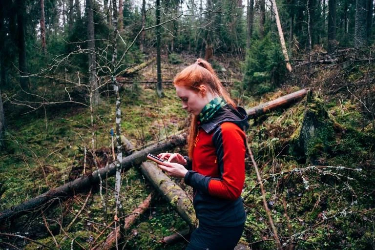 Finnish forest engineer Inna Salminen uses an application on her smartphone to control forests, to plan the maintenance work and to make sure that the protected areas in Finland are respected. (AFP)
