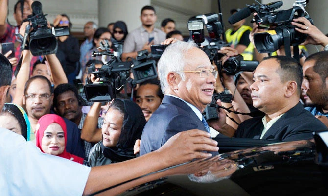Former Malaysian Prime Minister Najib Razak smiles as he leaves Kuala Lumpur High Court in Kuala Lumpur, Malaysia, Thursday, Nov. 15, 2018. (AP)