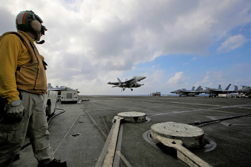 An F/A-18 Super Hornet fighter jet lands on the deck of the US Navy USS Ronald Reagan in the South China Sea on Tuesday, November 20. (AP)