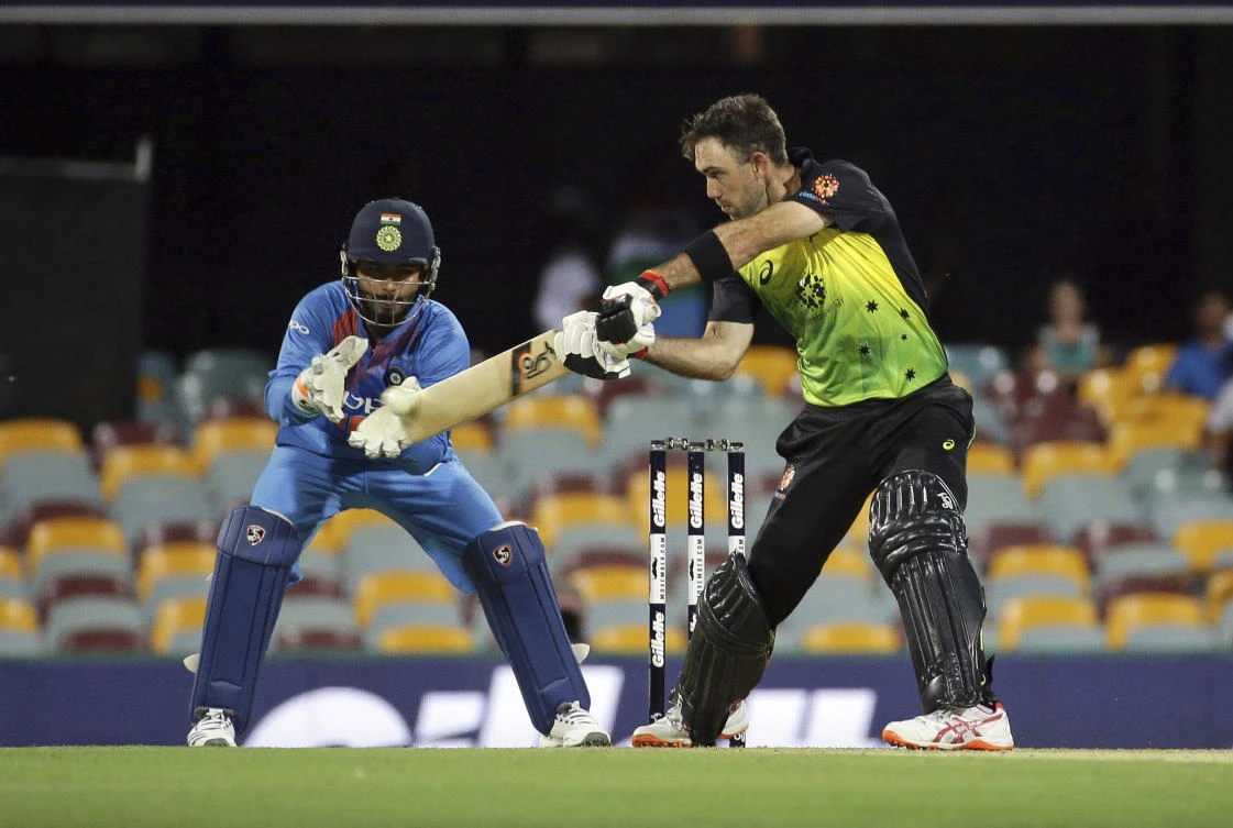 Australia's Glen Maxwell plays a shot as India's wicketkeeper Rishabh Pant, left, looks on during the first T20 International cricket match between Australia and India in Brisbane. (AP)