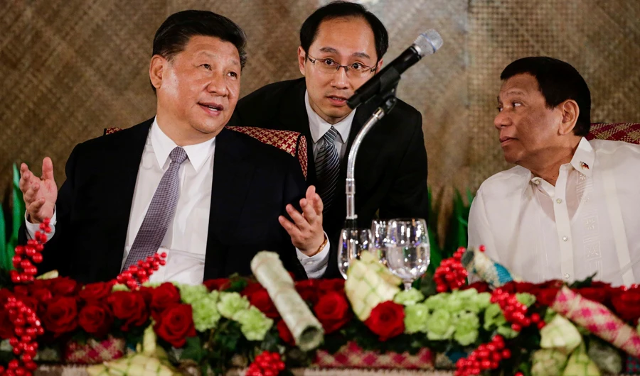 Chinese President Xi Jinping, left, Philippine President Rodrigo Duterte, right, talk during a state banquet at Malacanang Palace in Manila on Nov. 20, 2018. (Mark R. Cristino, Pool Photo via AP)
