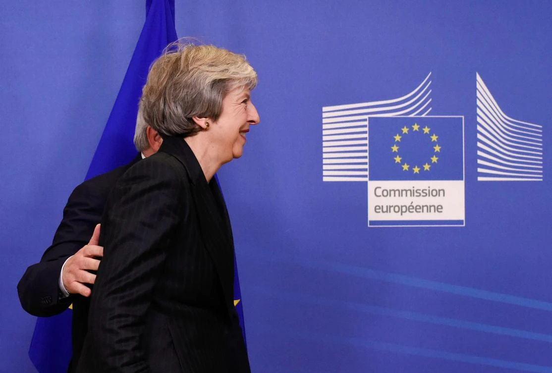 EU Commission President Jean-Claude Juncker and British Prime Minister Theresa May leave after a press briefing during a meeting at the EU Headquarters in Brussels on November 21, 2018. (AFP)