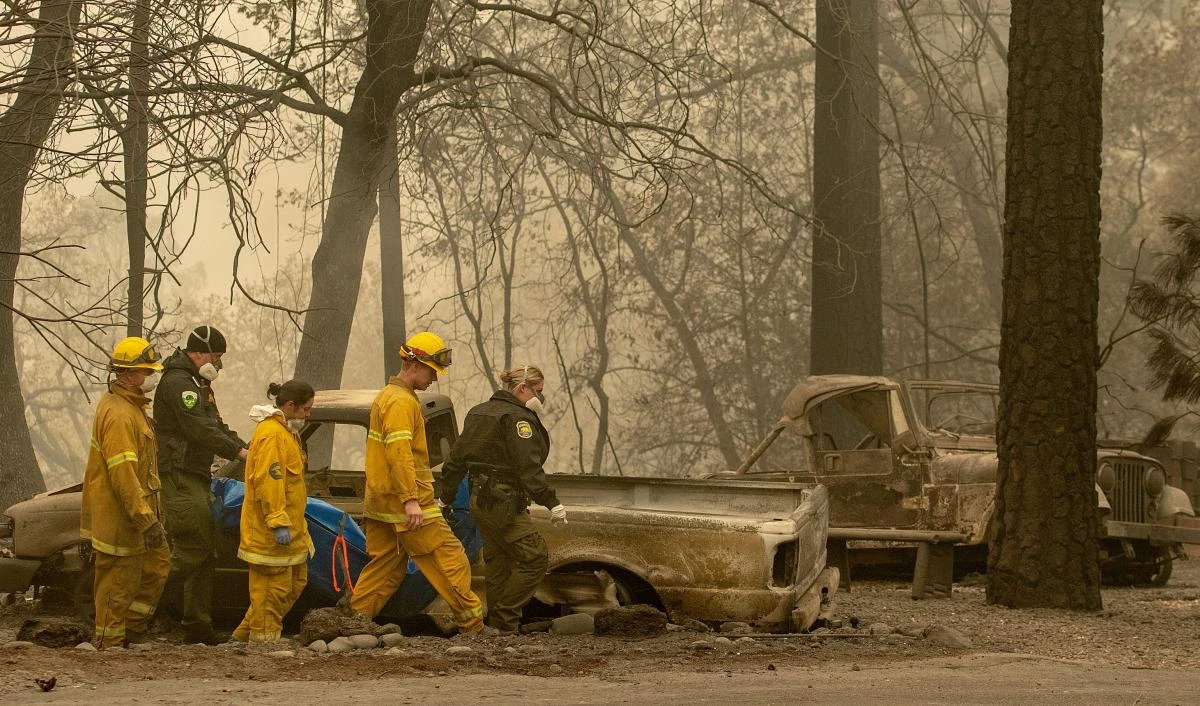 Rescue workers carry a body away from a burned property in the Holly Hills area of Paradise, California on November 14. (AFP)