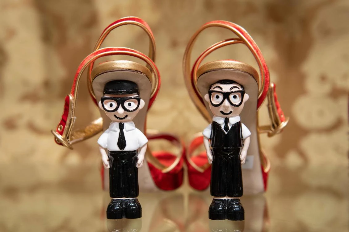 Shoes with the heels made out of figurines representing Italian fashion designers Domenico Dolce, left, and Stefano Gabbana are displayed at a Dolce & Gabbana shop in Beijing. (AFP)