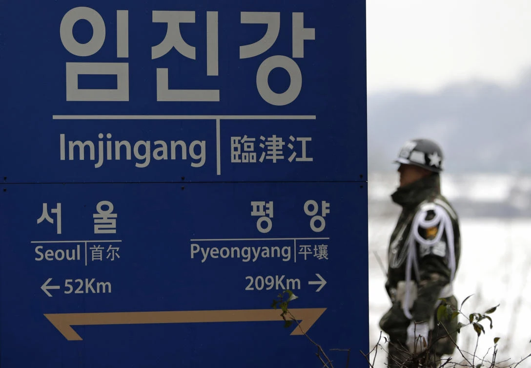 A South Korean soldier stands near a signboard showing the distance to North Korea’s capital Pyongyang and to South Korea’s capital Seoul from Imjingang Station in Paju, South Korea, Saturday, Nov. 24, 2018. (AP/Lee Jin-man)