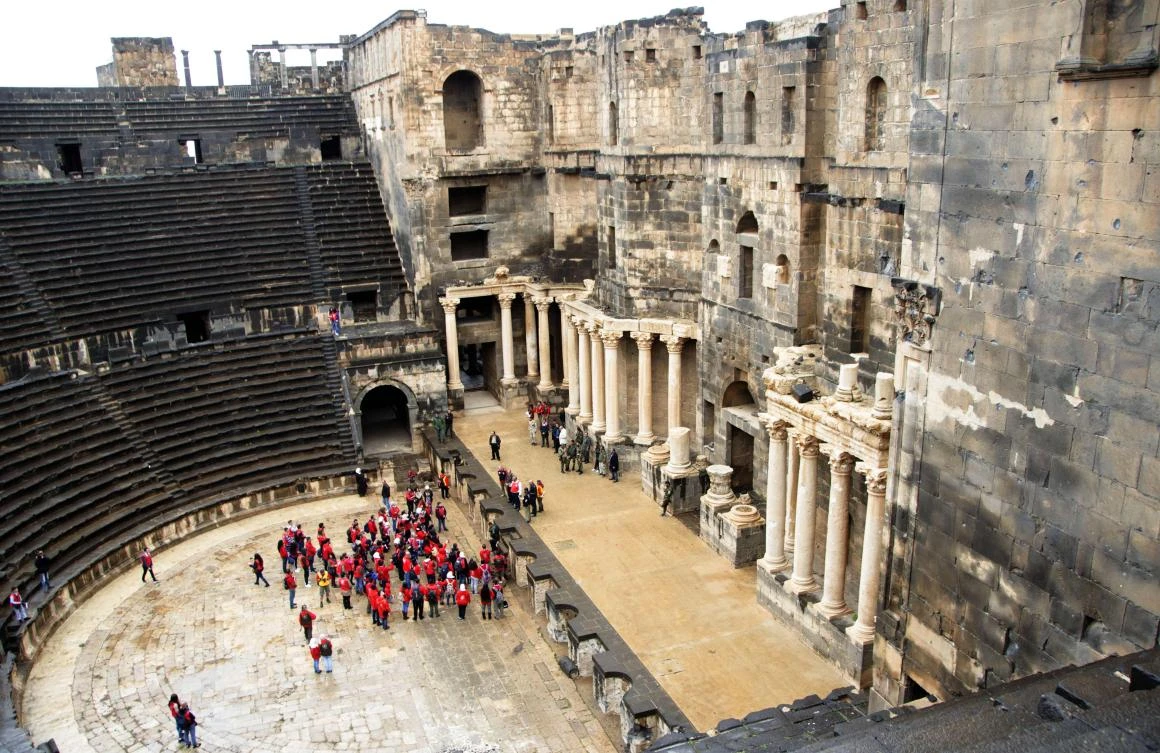 Syrian scouts tour the Roman Theatre at Bosra, a World Heritage Site, south of Sweida, in the Daraa province. (AFP)