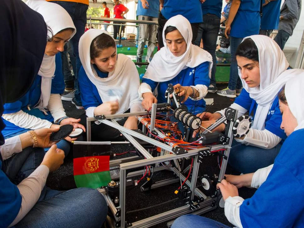 Members of the Afghan all-girls robotics team make adjustments to a team robot in the practice area on July 17, 2017. Afghan women are considered among the most resilient in the world since they work against multiple odds and challenges. (AFP/Getty Images/file)