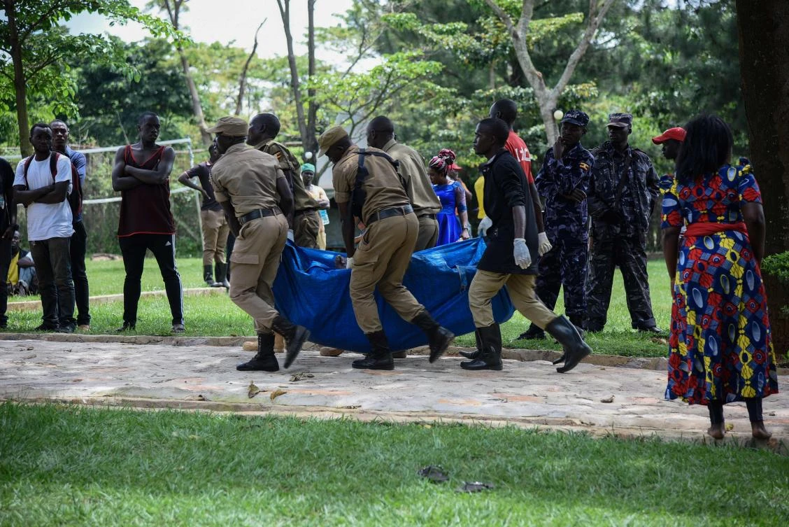 People carry a victim's body onto shore at the rescue site of a capsized cruise boat on Lake Victoria in Mutima village, south of Kampala, Uganda, on November 25, 2018. (AFP)