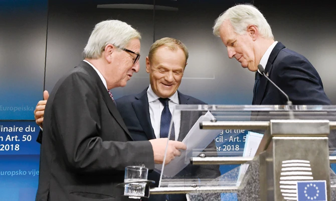 The president of the European Commission Jean-Claude Juncker, left, EU chief Brexit negotiator Michel Barnier, right, and European Council President Donald Tusk at the end of a press conference following a special meeting of the European Council to endorse the draft Brexit withdrawal agreement on Sunday. (AFP)