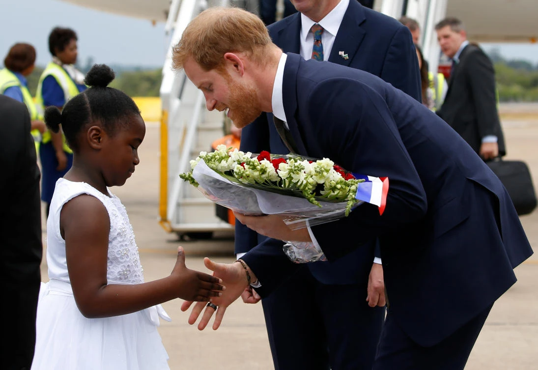 Britain's Prince Harry greets a child as he arrives at Kenneth Kaunda International Airport in Lusaka, Zambia, November 26, 2018. (Reuters)