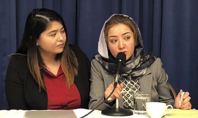 Mihrigul Tursun, right, speaks at a event at the National Press Club in Washington on Nov. 26, 2018. Tursun, a member of China' Uighur minority detailed the torture and abuse she suffered at the hands Chinese authorities as part of an escalating clampdown on hundreds of thousands of members of the country's Muslim minorities. (AP Photo/Maria Danilova)