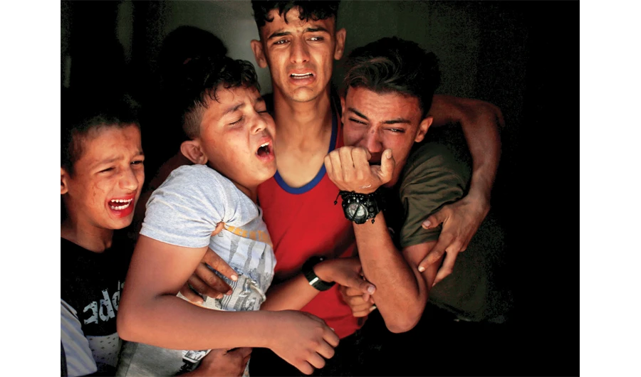 Relatives of a Palestinian, who was killed at the Israel-Gaza border, react at a hospital in Gaza City on June 18. (Reuters)