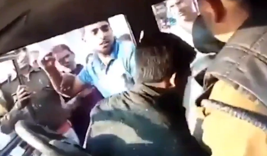 The man was dragged out of a police car and beaten to death. (Video screengrab)
