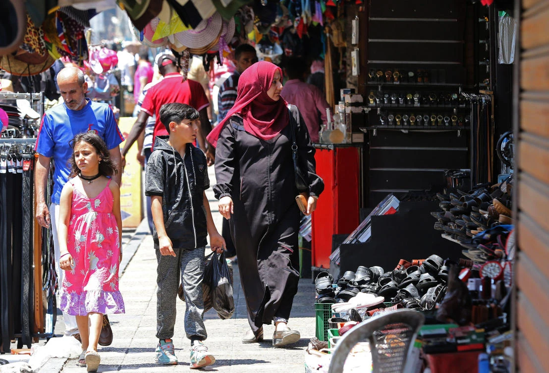 People stroll in a traditional market in downtown Amman. Jordan is among the Middle East countries that has received aid from Gulf oil exporters. (AFP)