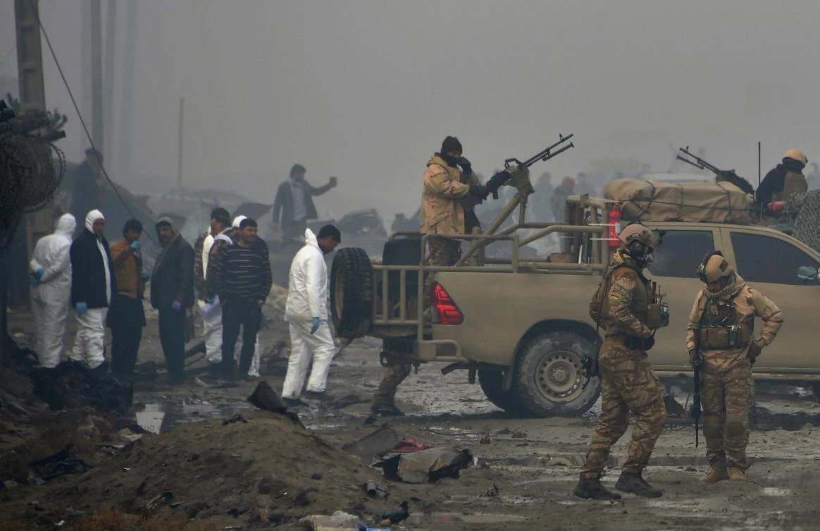 Afghan security forces and investigators gather at the site of a suicide bomb attack outside British security firm G4S’ compound in Kabul. (AFP)