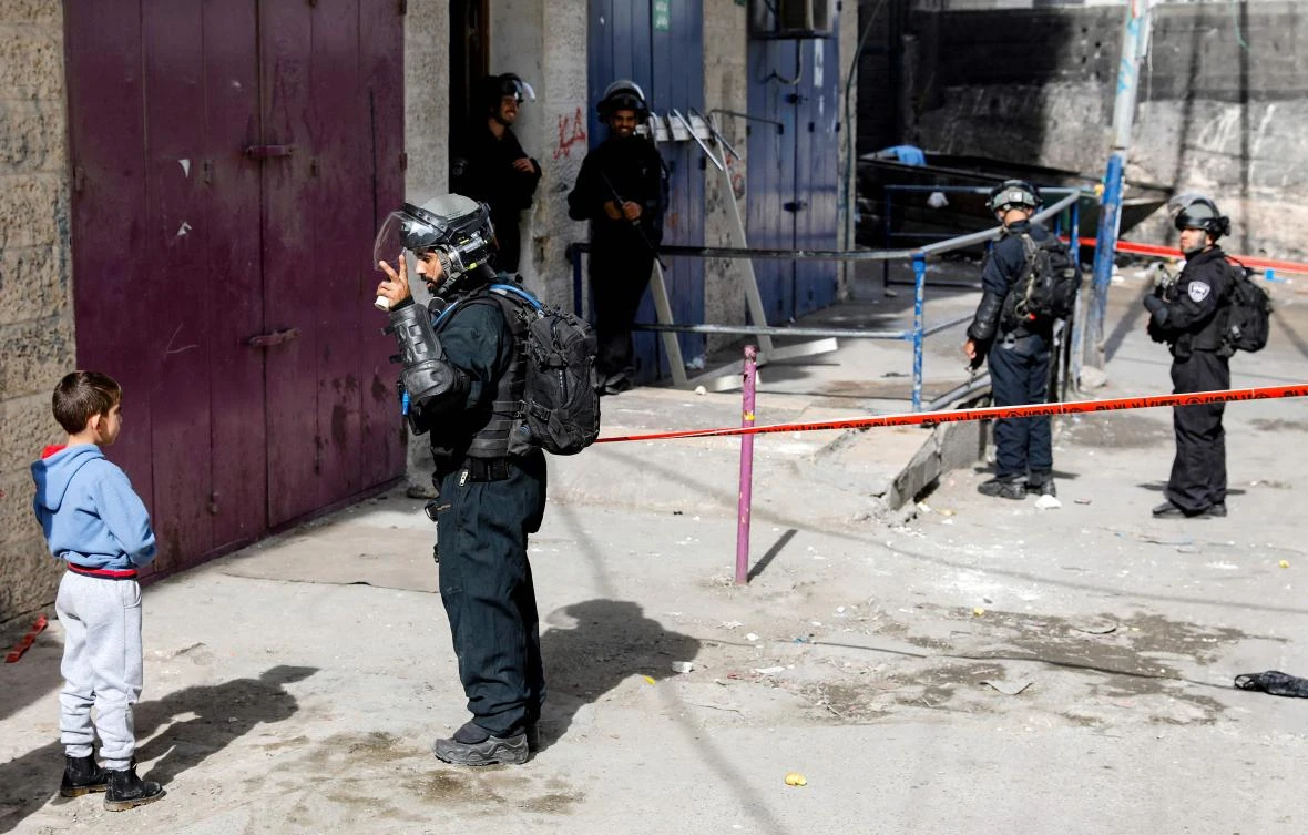 Members of the Israeli security forces form a security perimeter as excavators of the Jerusalem municipality (unseen) demolish over a dozen shops in the Arab-inhabited Shuafat refugee camp in Israeli-annexed East Jerusalem on November 21, 2018, which authorities said were built without a permit. (AFP)