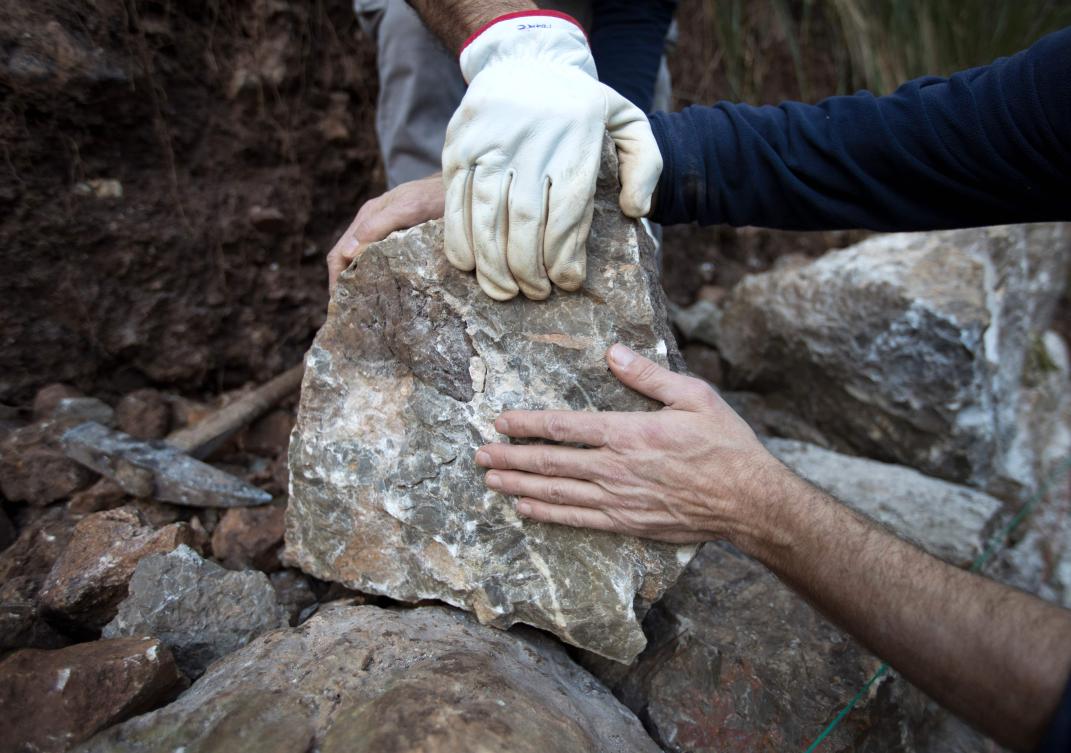 Some men build a wall using the dry stone technique in Esporles on the Spanish Balearic Island of Mallorca on December 11, 2018. The art of dry stone walling, inscribed in 2018 on the Representative List of the Intangible Cultural Heritage of Humanity, (sometimes called drystack) is a building method by which structures are constructed from stones without any mortar to bind them together. Dry stone structures are stable because of their unique construction method, which is characterized by the presence of a load-bearing facade of carefully selected interlocking stones. / AFP / JAIME REINA
