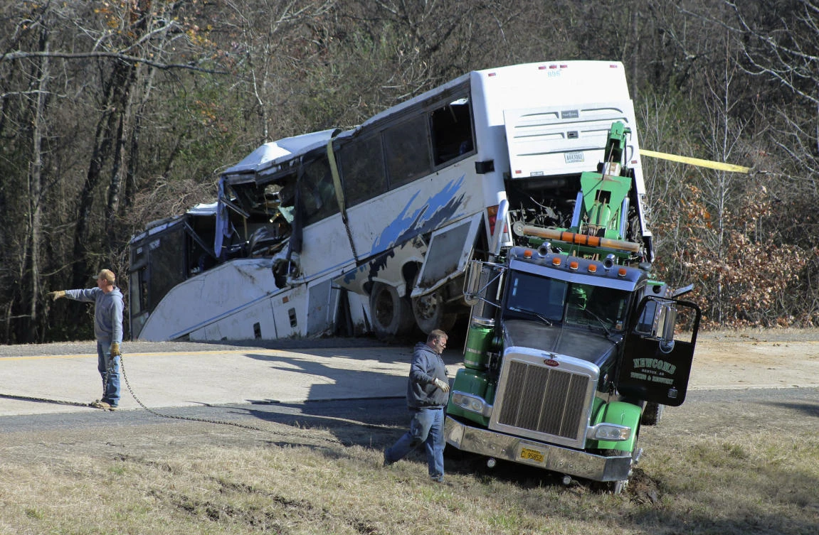 Employees from a wrecker service work to remove a charter bus from a roadside ditch Monday, Dec. 3, 2018, after it crashed alongside Interstate 30 near Benton, Arkansas. (AP)